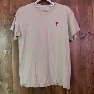 Beige shirt from PacSun. Crocheted rose on left side.